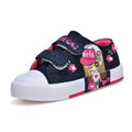 Blue denim girls canvas shoes with pink velcro straps cartoon girl design and floral embellishments on dark denim