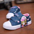 Blue denim girls canvas shoes with cartoon girl design, pink velcro straps, pearl embellishments, and white rubber soles