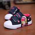 Blue denim girls canvas shoes with cartoon girl design featuring pink velcro straps and white rubber toe caps