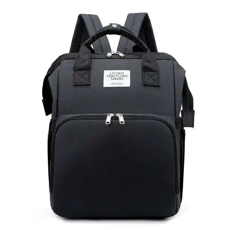 Black fabric backpack with silver zippers and white living traveling share label for blue denim large capacity mommy bag