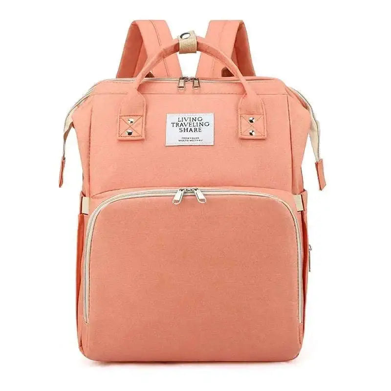 A coral fabric maternity backpack with beige zipper pulls and metallic accents for blue denim large capacity mommy bag