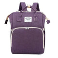 Purple fabric backpack with beige zipper pulls and trim featuring front pocket and top handle for denim large capacity mommy bag