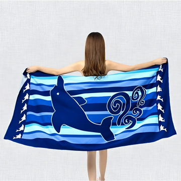 Blue dolphin and fish motif printed beach towel with striped pattern and dolphin silhouette for beach use near palm trees