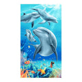 A vibrant blue printed beach towel with dolphin and fish motif featuring coral reefs and palm trees design