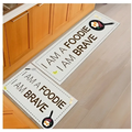 White rectangular kitchen mat with black text and frying pan illustrations by blue fish machine washable door mats