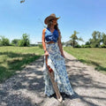 Woman wearing a blue floral split print pleating big hem skirt paired with a blue denim crop top and beige boots