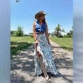Woman wearing a white floral big hem skirt with blue floral split print pleating paired with beige cowboy boots and tan hat