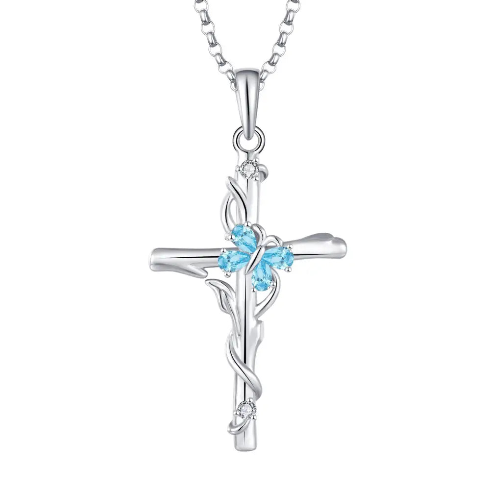Silver blue gemstone cross necklace featuring delicate vine design with three light blue and clear stones sterling silver women