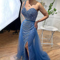 A royal blue handmade beaded split shoulder fishtail evening gown with sequined bodice and sheer tulle skirt