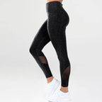 Black textured leggings with blue heathered mesh panels on the sides for mesh yoga fitness activities