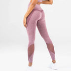 Pink heathered mesh yoga fitness leggings with mesh panel accents designed for comfort and style during workouts