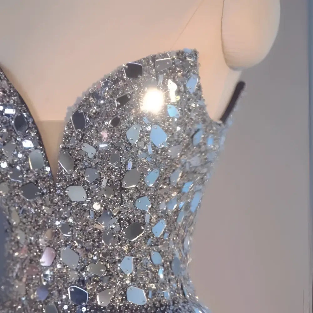 A shimmering silver sequined bodice with fitted structure on a blue heavy industry wedding evening dress