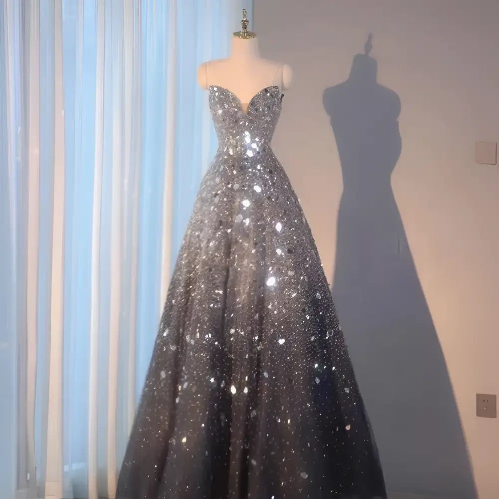 A shimmering silver and black gradient wedding evening dress with sweetheart neckline and sequins for heavy industry wedding