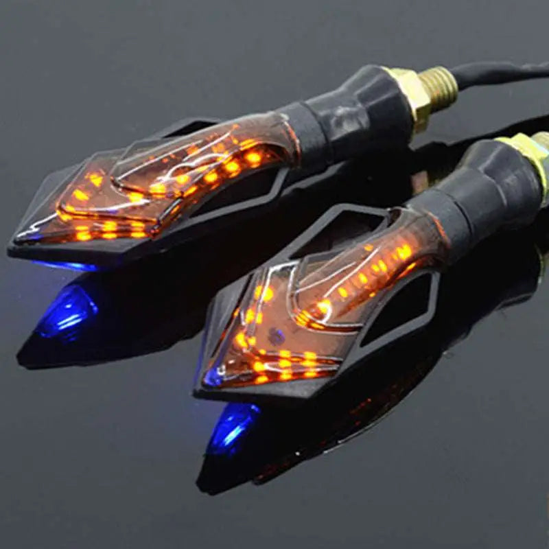 Two amber led motorcycle turn signals with black housing and brass connectors featuring a sleek angular design for motorcycle modification accessories