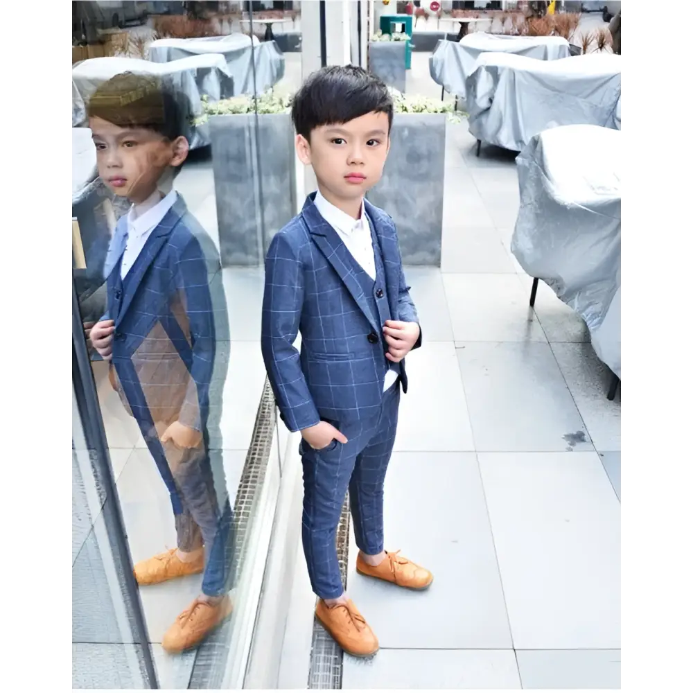 Blue plaid children’s three-piece fashion suit with white shirt and tan leather shoes for comfort and style