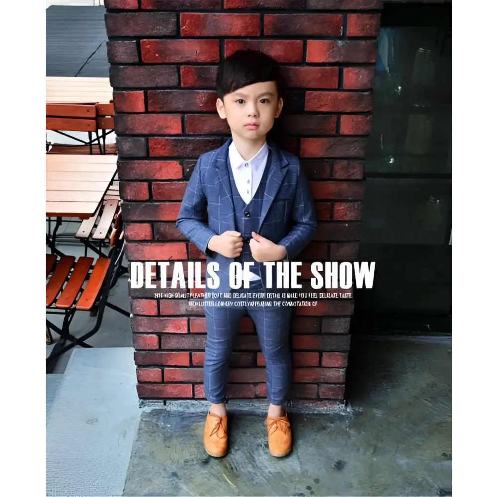 A child wearing a blue plaid children’s three-piece fashion suit with matching vest and tan leather shoes for comfort use
