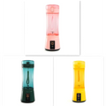 Pink and transparent plastic portable electric fruit juicer with black power button usb rechargeable mixer base