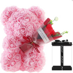 Pink rose bear covered with preserved rose flowers next to a red rose bouquet and black gift box for gifting