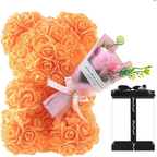 Orange rose bear figurine with pink ribbon and floral bouquet in clear packaging as a preserved rose flower gift box