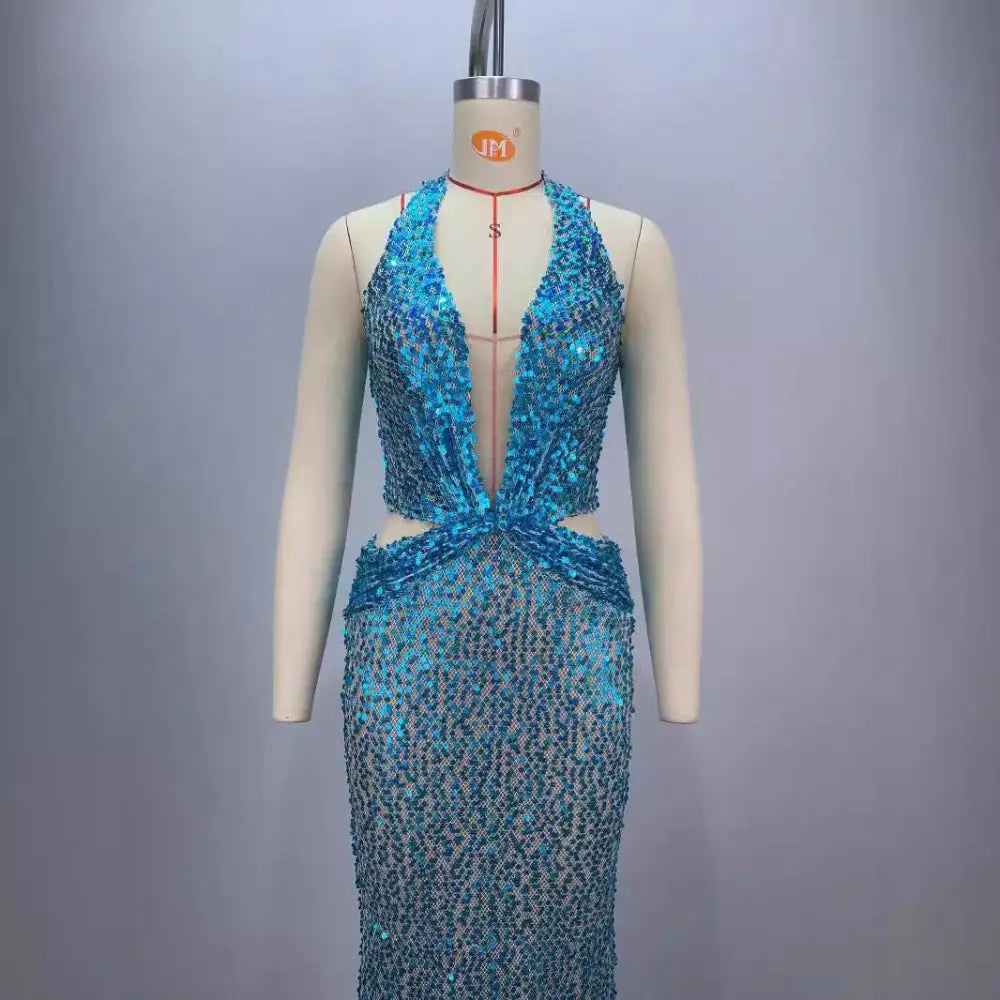 Back view of a shimmering turquoise sequined halter neck gown with deep v back and cinched waist for slimming party stage host use