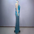 A shimmering turquoise sequined halter-neck slimming party stage host gown with fitted silhouette and cut-out sides on a mannequin
