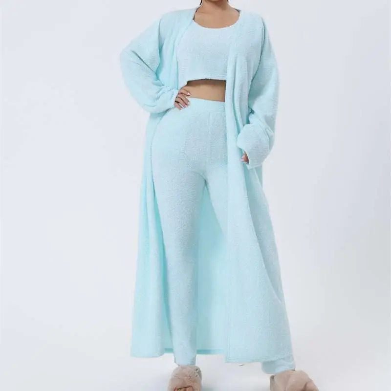 A cozy pajama set in blue shimmer knit featuring a cropped top with square neckline, wide-leg pants, and an open cardigan