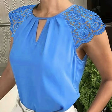 A vibrant blue sleeveless blouse with contrasting lace buttonhole and intricate lace detailing on the shoulders