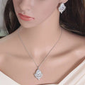 A sparkling silver necklace with a pear-shaped crystal pendant in the blue teardrop aaa jewelry set for dinner