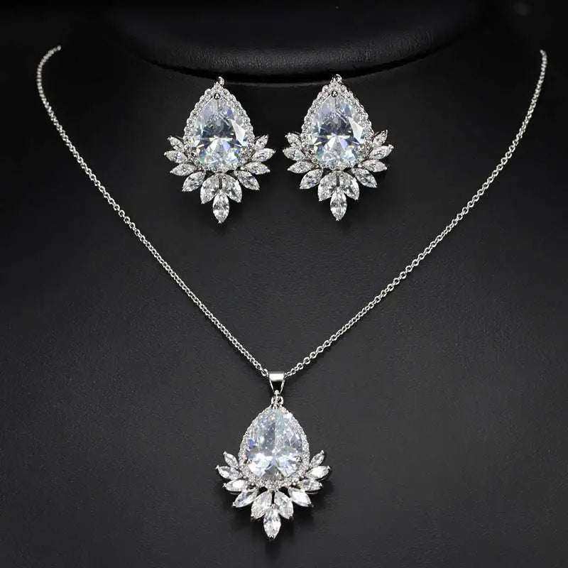 Elegant silver-toned blue teardrop AAA jewelry set with teardrop pendant and matching leaf design earrings for dinner