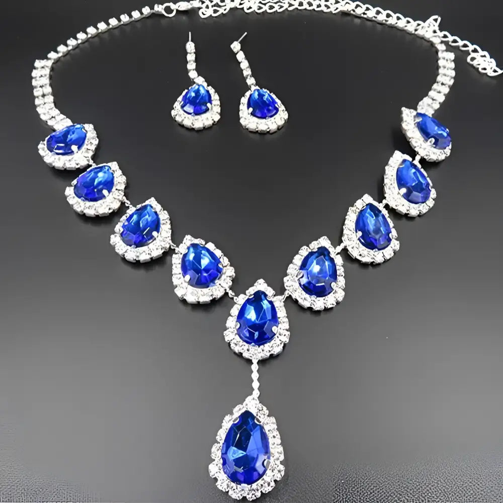 Elegant blue teardrop bridal jewelry set with color rhinestone crystals featuring a pendant necklace and matching earrings