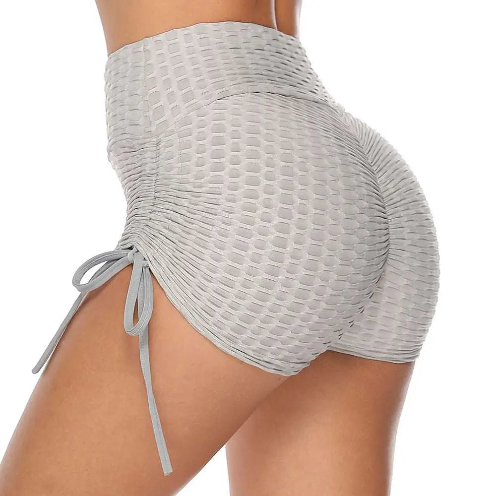 Light gray high-waisted textured butt lift drawstring shorts with mesh pattern and side tie details, back view