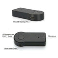 Black plastic bluetooth car aux adapter with circular power button usb charging port and 3.5mm audio jack for streaming a2dp wireless