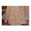 A blush beaded tulle luxury evening dress with delicate blush pink fabric and shimmering champagne-colored blush accents