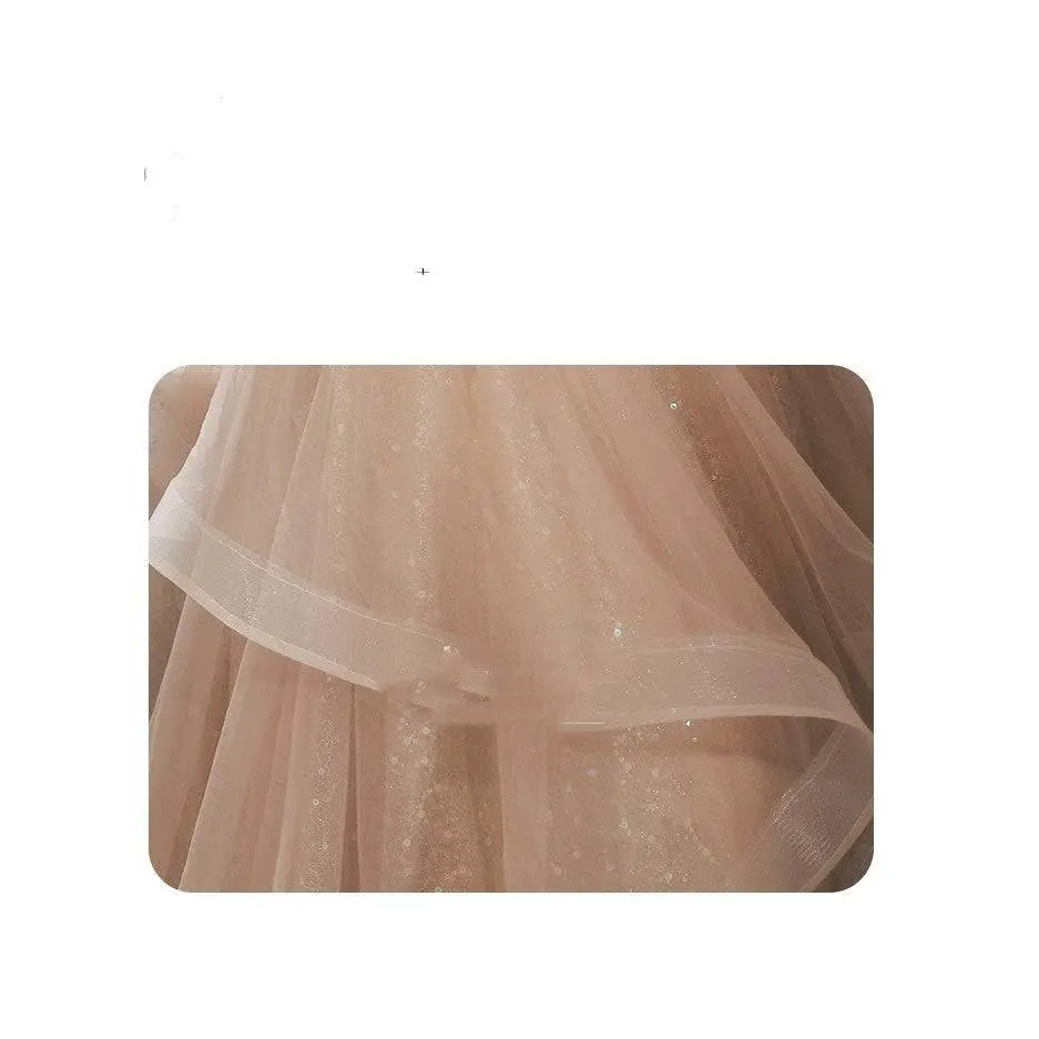 Blush beaded tulle luxury evening dress featuring a delicate blush pink skirt with shimmering champagne-colored blush embellishments