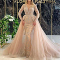 Blush pink beaded mermaid style wedding dress with long sheer lace sleeves and intricate silver beading on bodice