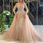 Blush pink beaded mermaid style wedding dress with long sheer lace sleeves and intricate silver beading on bodice