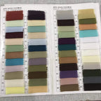 A fabric swatch catalog displaying multiple color options for 100d chiffon material in a blush pink lace long prom dress slit