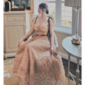 A blush pink lace slim drawstring gown with black polka dots featuring a fitted bodice and flowing skirt