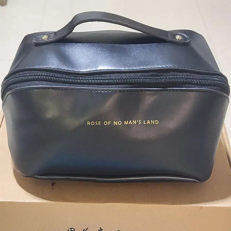 Black faux leather travel cosmetic bag with gold foil lettering rose of no mans land and top handle blush pink large capacity makeup bag