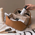 Tan leather makeup bag with zipper closure and interior compartments for blush pink large travel cosmetic bag use