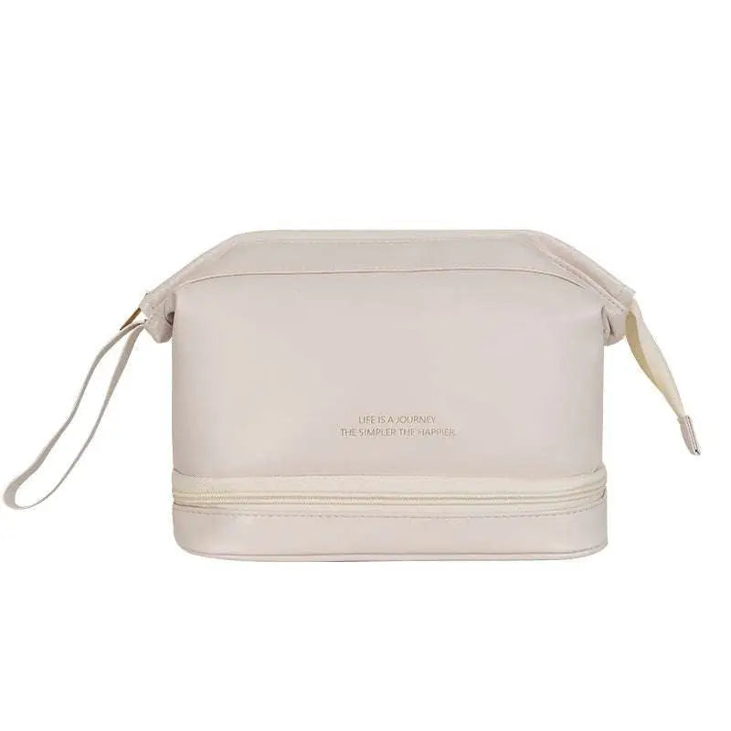 Cream-colored travel cosmetic bag with two compartments and subtle embossed text in a blush pink large capacity style