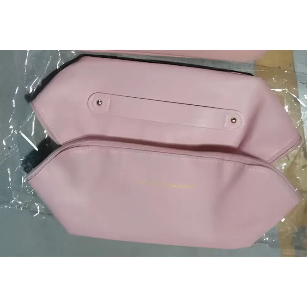 Blush pink large travel cosmetic bag with hexagonal shape gold-tone zipper and detailed stitching makeup bag
