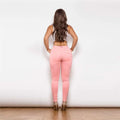 A pair of blush pink melody hot shaping leggings with a high-waisted design and subtle back pockets visible from the back