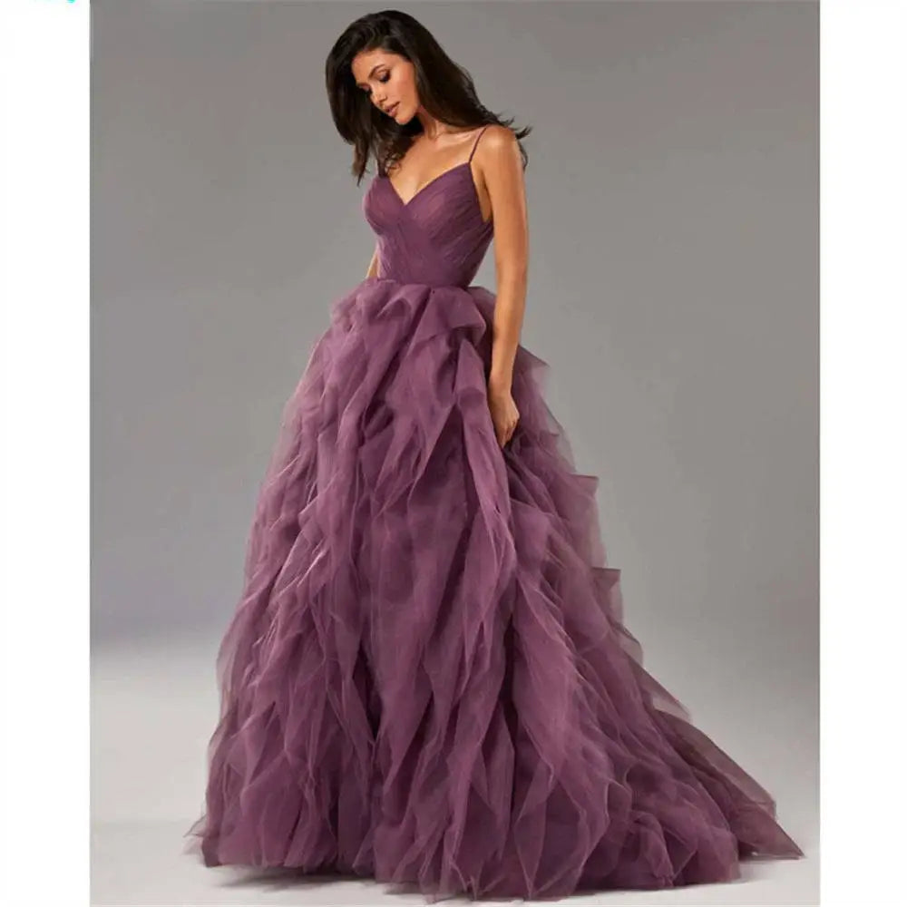A flowing deep purple tulle gown prom with a fitted bodice and layered ruffles evening gown prom detail