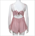 Blush pink romper image showing back with bow detail and thin straps in luxury women’s fashion style