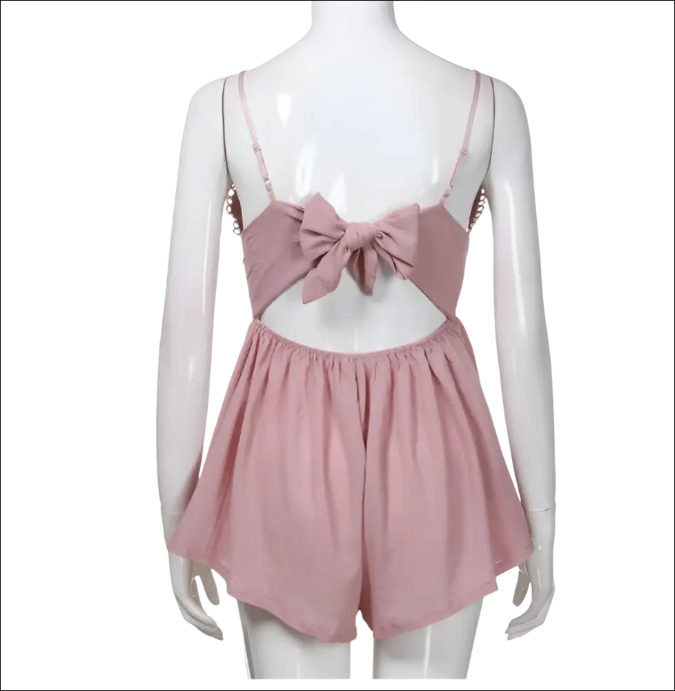 Blush pink romper image showing back with bow detail and thin straps in luxury women’s fashion style