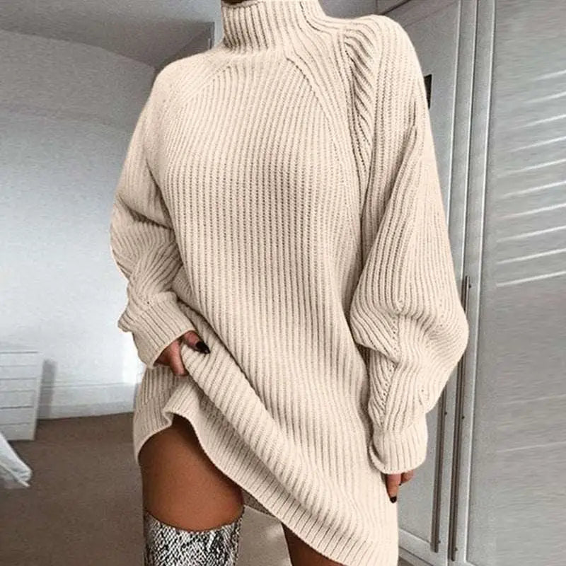 Cream-colored ribbed knit turtleneck long sweater with voluminous sleeves and high-low hemline for winter wear
