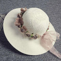 Delicate off-white woven straw hat with blush rose wedding garland flower crown of mauve and brown fabric roses and pink ribbon bow
