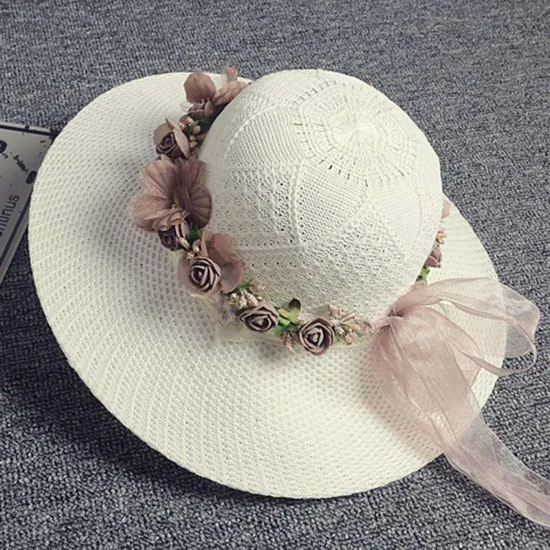 Delicate off-white woven straw hat with blush rose wedding garland flower crown of mauve and brown fabric roses and pink ribbon bow