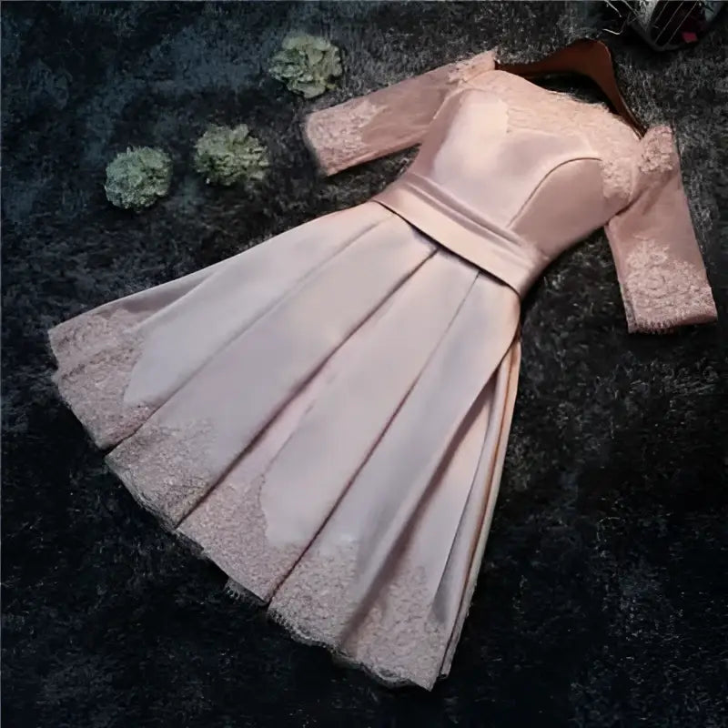 Blush satin lace evening dress featuring lace trim sleeves and hem with fitted bodice for bride wedding toast events